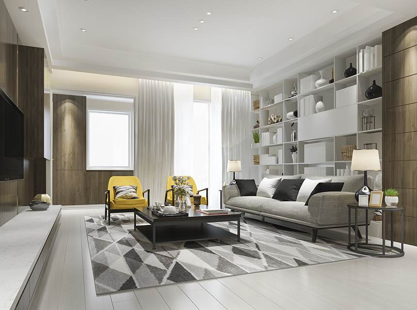 A living room with white walls and grey furniture.