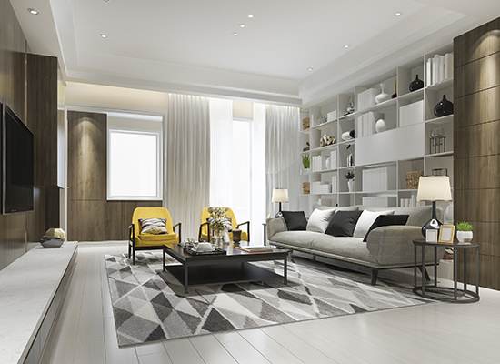 A living room with white walls and grey furniture.