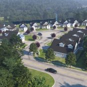 An aerial view of a neighborhood with houses and trees.